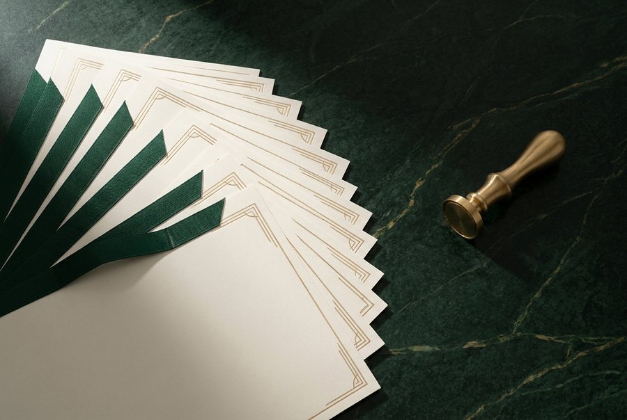 Incorporation certificates with green ribbon binding beside a brass company seal press